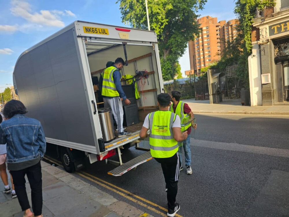 The team of a moving company is loading packed stuff from a home into the truck.